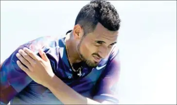  ?? RICHARD HEATHCOTE/GETTY IMAGES/AFP ?? Nick Kyrgios holds his shoulder while playing John Millman in their first-round match on day three of the 2017 US Open in New York on Wednesday.