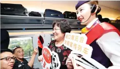  ??  ?? A railway attendant briefs passengers on informatio­n about the first China Internatio­nal Import Expo (CIIE) on board the G2 bullet train in east China’s Shanghai, Oct. 10, 2018. (Xinhua/Chen Fei)