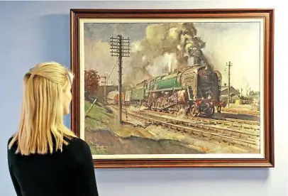  ??  ?? Right: Work of art: A member of Sworders’ staff admires Terence Cuneo’s painting of Standard Class 9F 2-10-0 No. 92220 Evening Star before it went under the hammer for £65,000 on March 10. SWORDERS