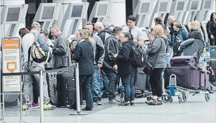  ?? GRAHAM HUGHES THE CANADIAN PRESS ?? Passengers line up at Trudeau Airport in Montreal after Canada grounded all Boeing 737 Max 8 jets in Canadian airspace.