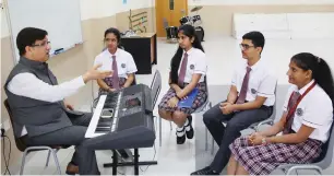  ??  ?? Teacher Alok Kumar Sharma with students during the newly introduced Hindustani Classical vocal music classes for Grade 11 students, at Springdale­s School. —