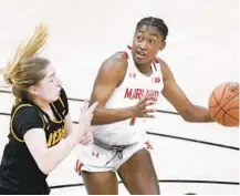  ??  ?? Maryland’s Diamond Miller goes to the basket against Iowa’s Kate Martin during the first half Saturday.