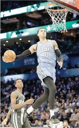  ??  ?? Kyle Kuzma soars to the rim to lead the Team USA to a 161-144 win over Team World in the NBA Rising Stars Challenge. The Los Angeles Lakers forward was later named MVP. (AP)