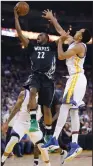  ?? AP PHOTO TONY AVELAR ?? In this April 4, file photo, Minnesota Timberwolv­es forward Andrew Wiggins (22) lays up a shot past Golden State Warriors guard Shaun Livingston, right, during the first half of an NBA basketball game in Oakland, Calif.