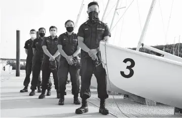  ?? [JESSICA HILL/ ASSOCIATED PRESS] ?? Coast Guard Academy Cadets, from left: Henry Smith, Branyelle Carillo, Mia Haskovec, Jordan Park and Tyler Huynh pose at the Seamanship Sailing Center at the United State Coast Guard Academy in New London, Conn. The cadets spent part of their summer filling in on a national security mission after a case of COVID-19 sidelined regular crew members.