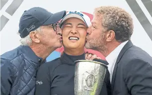 ?? LAURENT CIPRIANI THE ASSOCIATED PRESS ?? Jin Young Ko braces for victory kisses from Evian Championsh­ip president Franck Riboud, left, and event vice-president Jacques Bungert after Sunday’s major triumph.