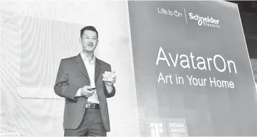  ??  ?? Heng is seen holding the AvatarOn switch while making a speech at prior to the launch of Schneider Electric’s AvatarOn switch.The AvatarOn is the world’s first range of customisab­le and printable switch that can be personalis­ed to fit seamlessly into...