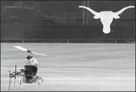  ?? AP ?? A drone flies in Darrell K. Royal Memorial Stadium during an experiment run by Todd Humphreys, director of the University of Texas Radionavig­ation Laboratory in Austin. Texas is among seven states to pass laws limiting drone use in civilian airspace.