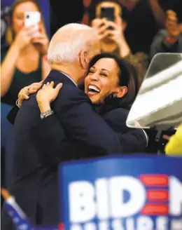  ?? Jeff Kowalsky / AFP / Getty Images ?? Kamala Harris and Joe Biden embrace after she endorsed him March 9.