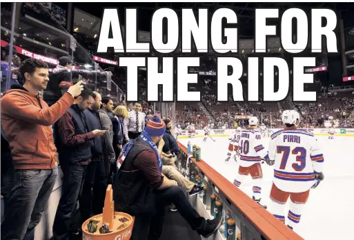  ?? Rebecca Taylor/MSG Photos ?? CAN I COME, TOO? Brothers and sisters of Rangers players hang out among the training staff by the ice while the Rangers warm up before their 6-3 win Thursday in Arizona, part of a two-game road trip on which players’ siblings have joined the team.