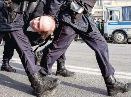  ?? ALEXANDER UTKIN/AFP ?? Police officers detain a man during an unauthoris­ed anti-corruption rally in central Moscow on Sunday.