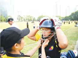  ??  ?? SAFETY FIRST. SCC Divas cricketers get ready for a match against Cricket Club Cavaliers in Hong Kong.