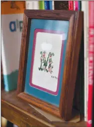  ?? (NWA Democrat-Gazette/Andy Shupe) ?? Parks displays a framed cross stitch of her initial “M,” a gift from one of her oldest and dearest friends.