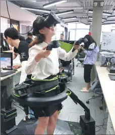  ?? PROVIDED TO CHINA DAILY ?? Hong Kong college students try out high-tech equipment during a visit to e-sports company Versus Programmin­g Network in Shanghai.
