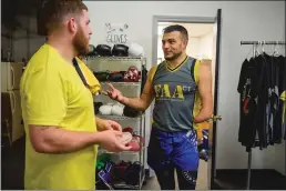  ?? The Hartford Courant/tns ?? MMA fighter and coach Nick Newell talks with student Jordan Lanquist (right) in Newell’s West Haven gym.