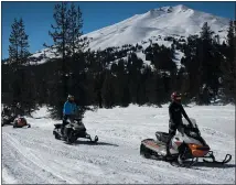  ??  ?? Explore Central Oregon’s spectacula­r snowy landscapes aboard a snowmobile. Central Oregon Adventures leads customized, guided tours from the Wanoga Sno-park near Mount Bachelor.