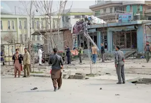  ?? AP ?? Security personnel inspect the site of a suicide attack in Kabul on Friday. —