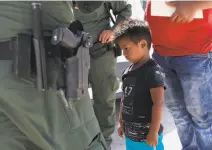  ?? John Moore / Getty Images ?? A boy and father from Honduras were recently taken into custody by Border Patrol agents near Mission, Texas.