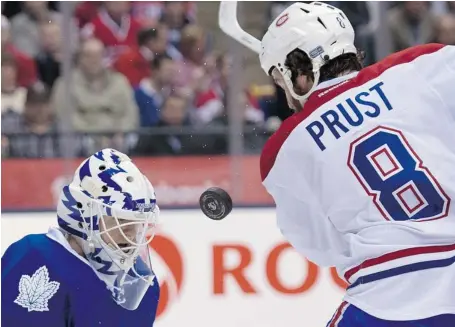  ?? FRANK GUNN/THE CANADIAN PRESS ?? Maple Leafs goaltender Ben Scrivens makes a save on Canadiens left winger Brandon Prust at the ACC in Toronto on Wednesday night.