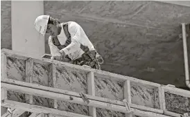  ?? Alan Diaz / Associated Press ?? A constructi­on employee works on a high-rise in Miami. The U.S. economy expanded in the January-March quarter at a 1.2 percent annual rate, the