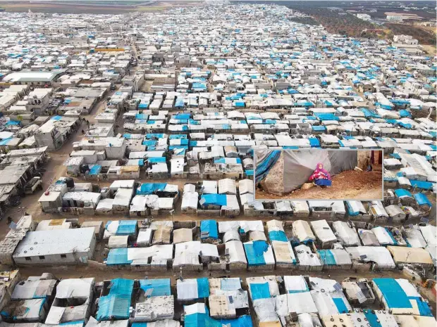  ?? (AP) ?? A general view of Karama camp for internally displaced Syrians by the village of Atma, Idlib province, Syria. Fallout from the 2-month-old war in Ukraine is worsening long-term humanitari­an crises elsewhere, including in Syria. Inset: A Syrian young woman holds a baby in a refugee camp for displaced people supported by the Turkish Red Crescent in Sarmada district, north of Idlib city, Syria.