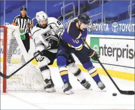  ?? Joe Puetz Associated Press ?? DREW DOUGHTY, left, defends against the Blues’ Oskar Sundqvist en route to a victory that pleased Kings coach Todd McLellan, who liked his team’s attack.