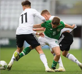  ??  ?? Seamas Keogh is tackled by Tim Lemperle, left, and Jannis Lang of Germany during the U17 Internatio­nal Friendly match between Republic of Ireland and Germany at Tallaght Stadium in Tallaght, Dublin. Pic: Eóin Noonan/Sportsfile