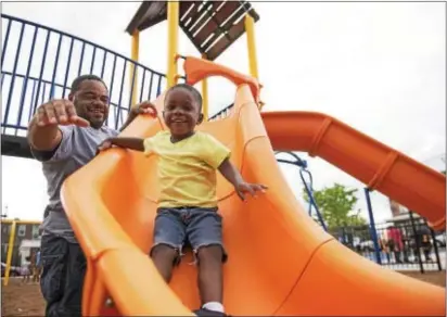  ?? RICK KAUFFMAN — DIGITAL FIRST MEDIA ?? Derrick Welles, left, plays with his son, Dylan Welles, 3, right, at Chester’s newest playground on the corner of Eighth and Lloyd streets.