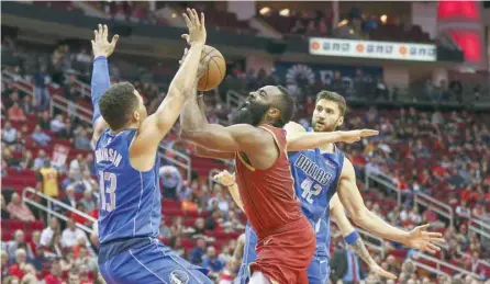  ?? — USA Today Sports ?? Houston Rockets guard James Harden (13) drives to the basket as Dallas Mavericks guard Jalen Brunson (13) and forward Maximilian Kleber (42) defend during the first quarter at Toyota Center.