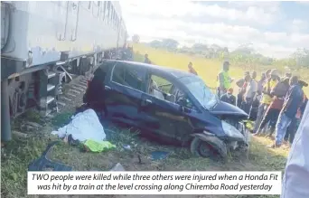  ?? ?? TWO people were killed while three others were injured when a Honda Fit was hit by a train at the level crossing along Chiremba Road yesterday
