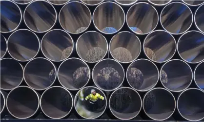  ?? Photograph: Jens Buettner/AP ?? Pipes stored for the Nord Stream 2 gas pipeline.