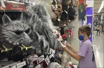  ?? Marta LAVANDIER / AP ?? A young customer looks at a halloween mask at a Party City store on oct. 6 in miami. Prices for U.s. consumers jumped 6.2% in october compared with a year earlier as surging costs for food, gas and housing left Americans grappling with the highest inflation rate since 1990.