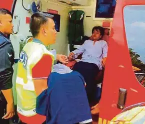  ??  ?? Emergency Medical Rescue Services personnel helping students from Sekolah Agama Taman Mawar in Pasir Gudang, Johor, into an ambulance yesterday.