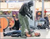  ?? AP ?? A man acting as a terrorist shoots a mock victim during a drill at the CologneBon­n airport, Germany, on Tuesday.