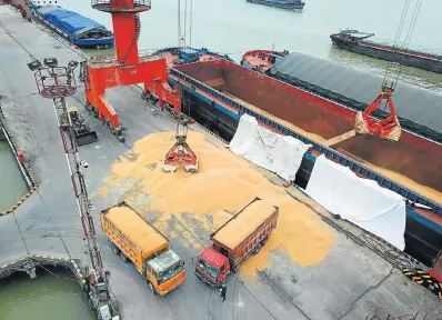  ?? Picture: AFP ?? FUTURE UNCERTAIN: Workers load imported soybeans onto trucks at a port in Nantong in China’s eastern Jiangsu province yesterday as China unveiled plans to hit major US exports