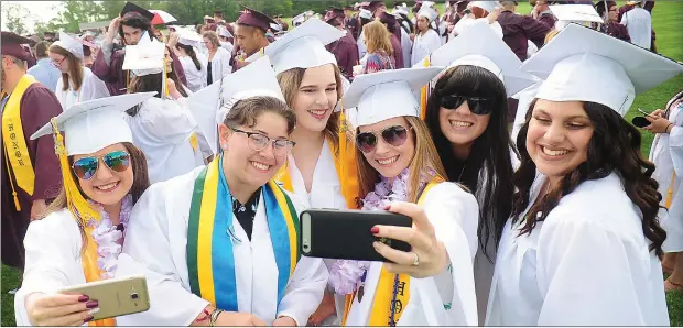  ?? Photos by Ernest A. Brown ?? ABOVE: Members of the Woonsocket High School Class of 2017, from left, Irie Chianese, Justice LaForest, Jessica Paquette, Kaylie Perrico, Kiara Poirier, and Vanessa Centeno, gather for a group selfie before taking part in graduation ceremony at Barry...