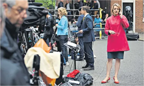  ?? ?? Face of politics: Laura Kuenssberg outside No 10 after the 2017 snap election. Below, interviewi­ng Boris Johnson in 2019