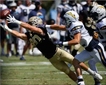  ?? AP PHoTo/JAE C. Hong ?? New Orleans Saints wide receiver Austin Carr (left) makes a catch under pressure by Los Angeles Chargers defensive back Micah Hannemann during the teams’ joint NFL football practice, on Wednesday,in Costa Mesa.