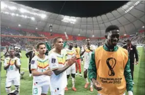  ?? (AFP) ?? Senegal’s players celebrate after defeating Ecuador 2-1 and qualifying to the next round, during the FIFA World Cup Qatar 2022 Group A match at the Khalifa Internatio­nal Stadium in Doha on Tuesday.