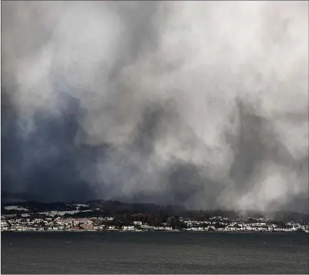  ??  ?? This image of falling snow over Dunoon was shot from Gourock on Tuesday by Herald reader Ronnie McFadyen.