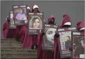  ?? KIN CHEUNG — THE ASSOCIATED PRESS ?? Activists hold placards reading “Woman, Life, Freedom” with portraits of women killed in Iran during a demonstrat­ion Wednesday to mark Internatio­nal Women's Day in London.