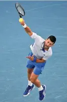  ?? Photograph: Anthony Wallace/AFP/Getty Images ?? Novak Djokovic serves against Adrian Mannarino during their fourth-round Australian Open match at Rod Laver Arena.