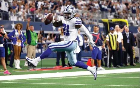  ?? AP Photo/Ron Jenkins ?? ■ Dallas Cowboys running back Ezekiel Elliott (21) high-steps to the end zone for a touchdown Sunday in the second half against the New York Giants in Arlington, Texas.