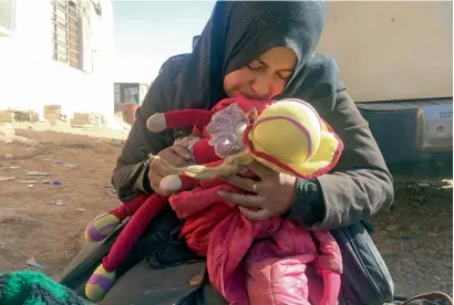  ?? AFP ?? Safana Hamad, a displaced Iraqi mother, holds her daughter Manar’s doll and jacket while mourning over her body, after the four-yearold was killed in a Daesh mortar attack while trying to flee fighting in western Mosul. —