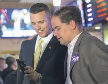  ?? Steph Chambers/Post-Gazette ?? Candidate for state Senate Jeremy Shaffer, left, looks at election results with Richard Kain of Sewickley on Tuesday at Pomodoro Restaurant in Franklin Park.