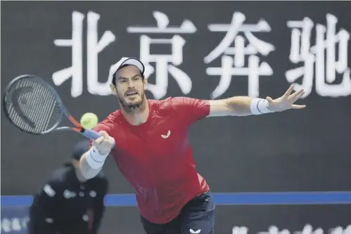  ??  ?? 0 Andy Murray plays a forehand return during his 7-6(6), 6-7(4), 6-1 victory over compatriot Cameron Norrie, below, at the China Open.