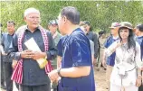  ??  ?? Secretary of State for the Cambodian Ministry of Culture Chuch Phoeurn, left, welcomes the Thai minister on the border. At right is Bangladesh­i Ambassador Saida Muna Tasneem.