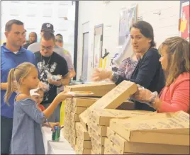  ??  ?? Mt. Hope/Nanjemoy students and their fathers or other male role models line up for pizza during the school’s WatchDOGS program kickoff last week.