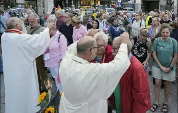  ?? Martin Meissner/Associated Press ?? Married and same-sex couples take part in a public blessing ceremony on Sept. 20 in front of the Cologne Cathedral in Cologne, Germany. The Vatican said Monday that Pope Francis had allowed priests to bless same-sex couples, his most definitive step yet to make the Roman Catholic Church more welcoming to LGBTQ+ Catholics and more reflective of his vision of a more pastoral, and less rigid, church.