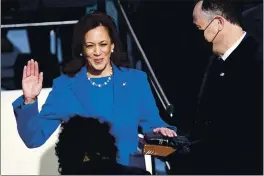  ?? SAUL LOEB — POOL PHOTO ?? Kamala Harris is sworn in as vice president by Supreme Court Justice Sonia Sotomayor as her husband, Doug Emhoff, holds the Bible during the 59th presidenti­al inaugurati­on at the U.S. Capitol in Washington on Wednesday.